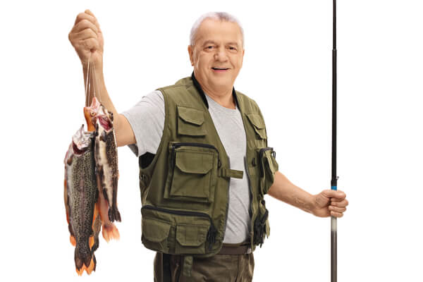 フィッシングベストを着用して釣りをするおじいさん